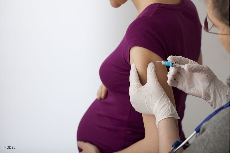 Pregnant woman getting the flu shot to protect herself and her baby
